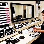 **Image of a beautician meticulously organizing income and expense records, highlighting categories like salon income, product sales, salon rent, product purchases, and equipment costs. The scene should convey financial responsibility and organization.**